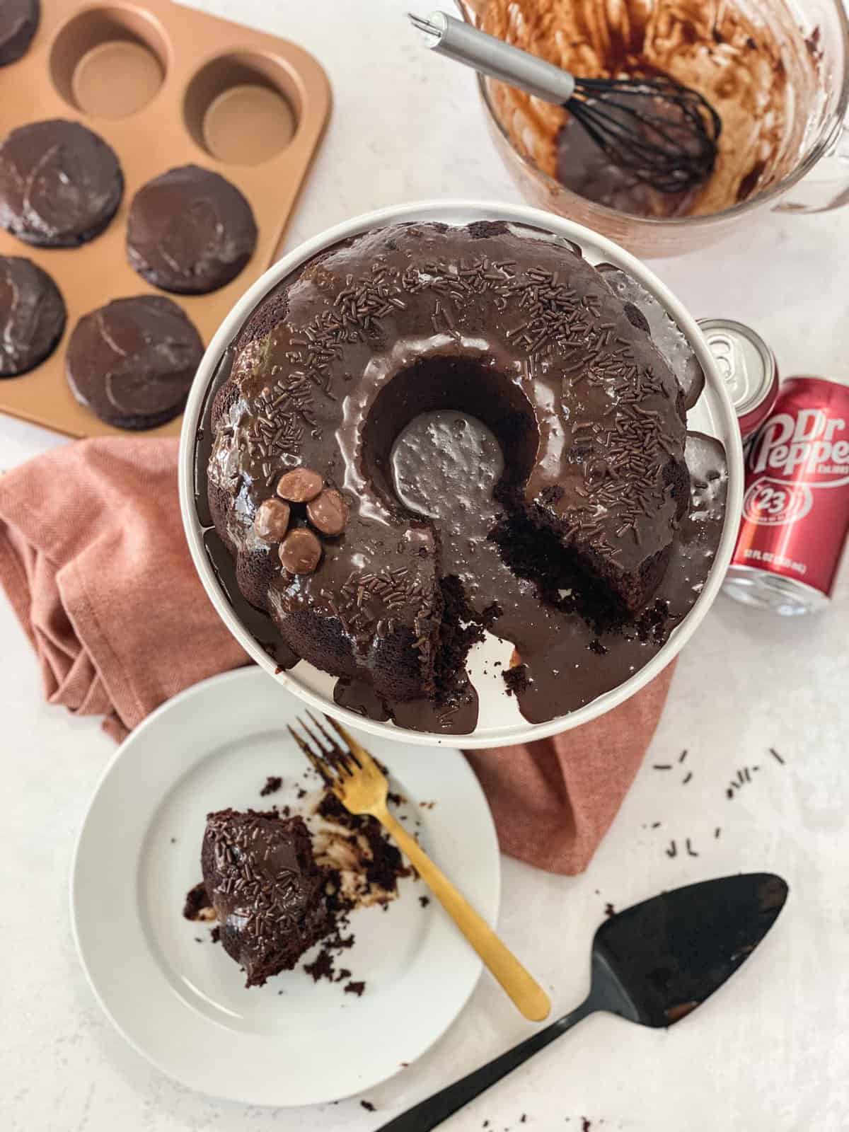 Dr Pepper Cake overhead shot with cake slice on a plate and soda can