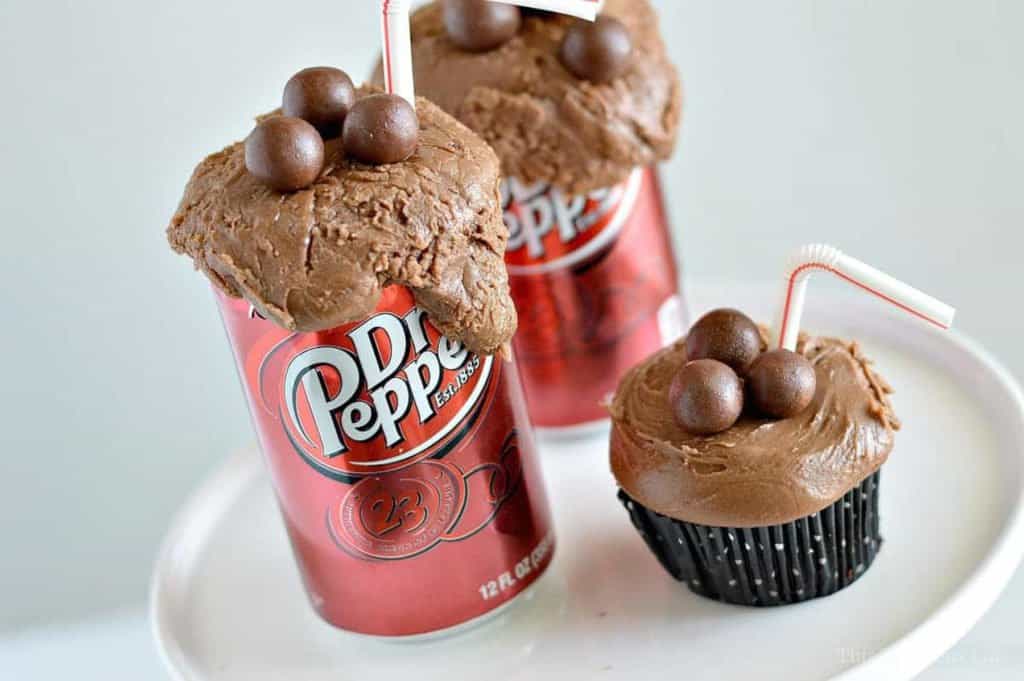 Dr Pepper Cupcakes in a black cupcake liner on a cake stand