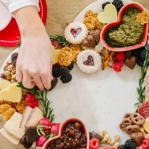 Valentines charcuterie board heart with cookies, cheese and more