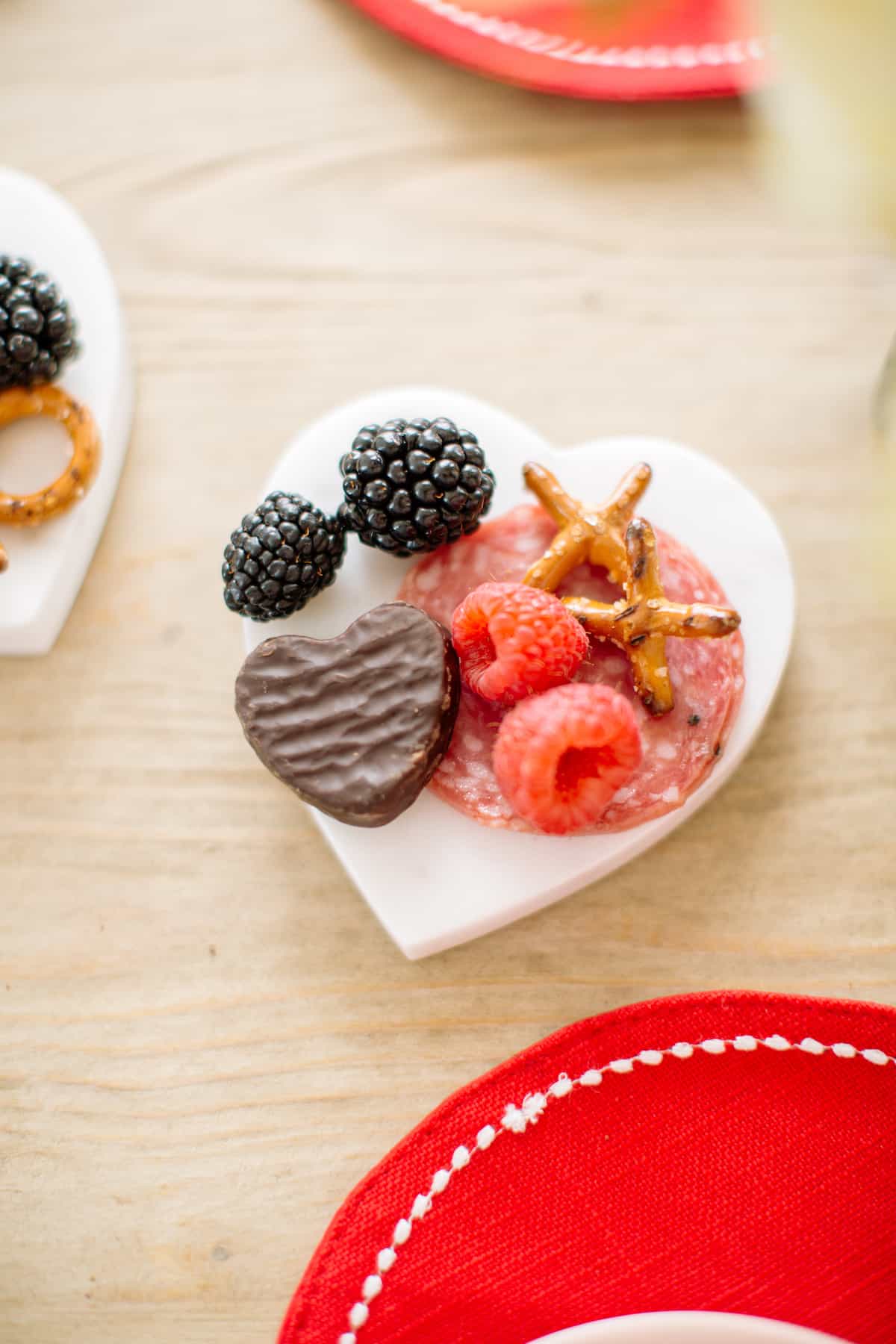 Mini marble heart charcuterie board with chocolates, pretzels and more