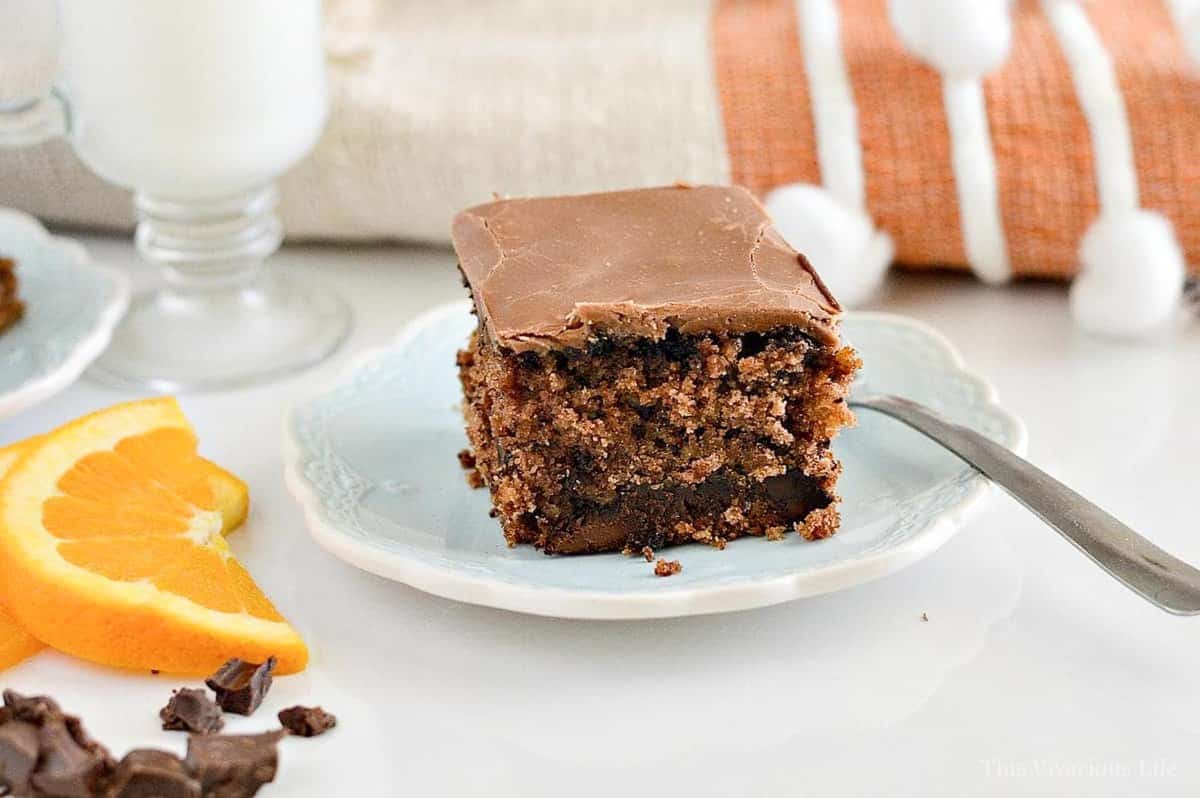 Chocolate Orange Cake on a blue plate with orange slices