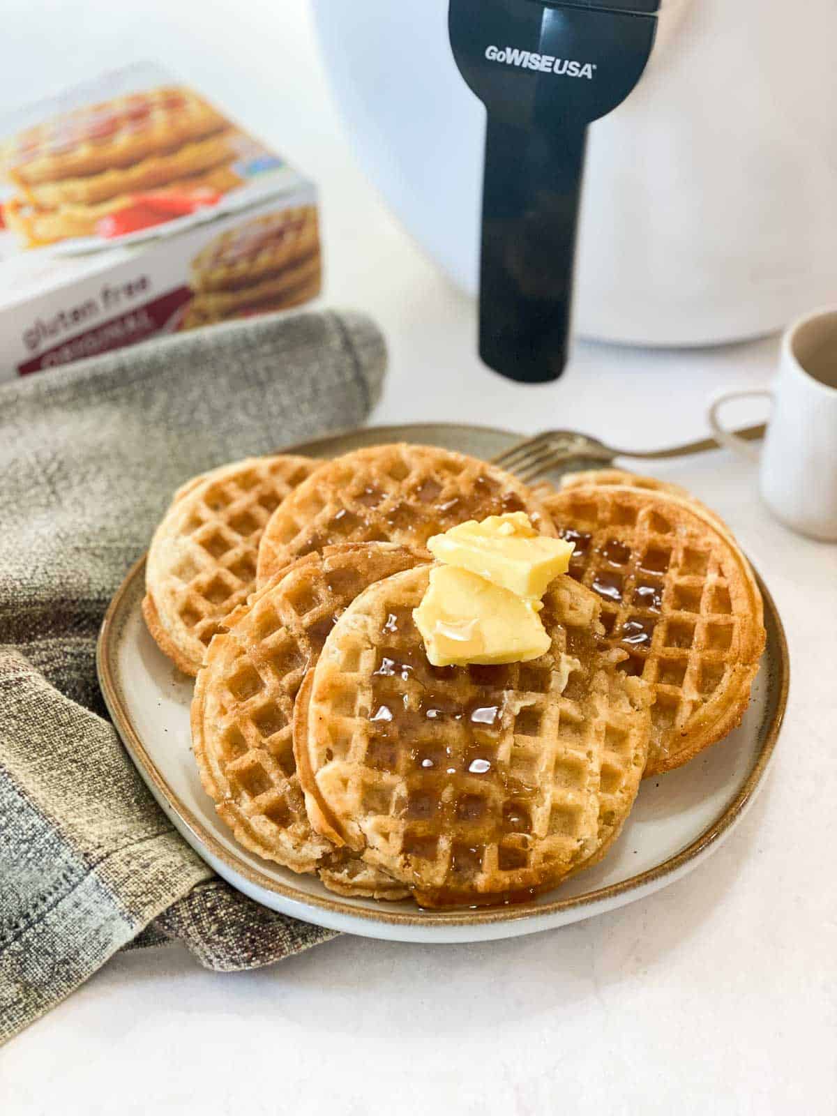 Cooked frozen waffles with syrup and butter