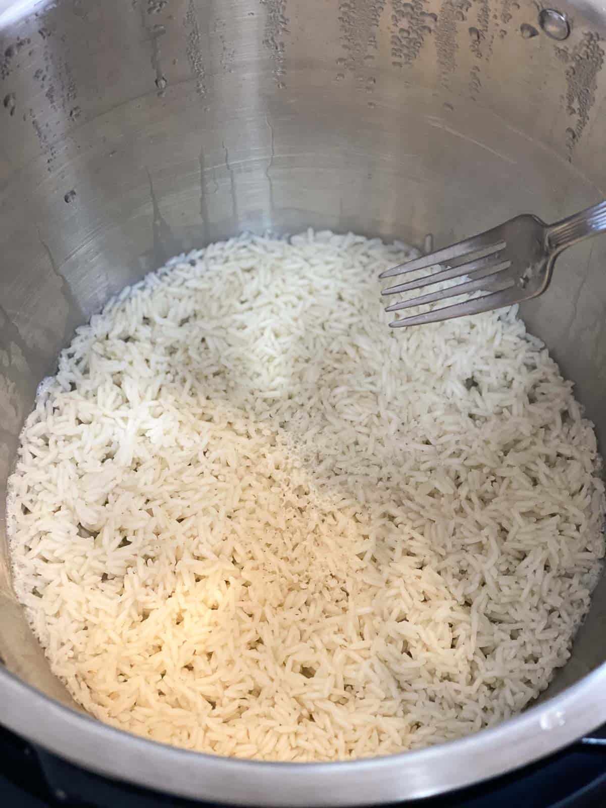 Rice in instant pot with fork stirring it