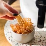 waffle fries in air fryer cooked in a bowl