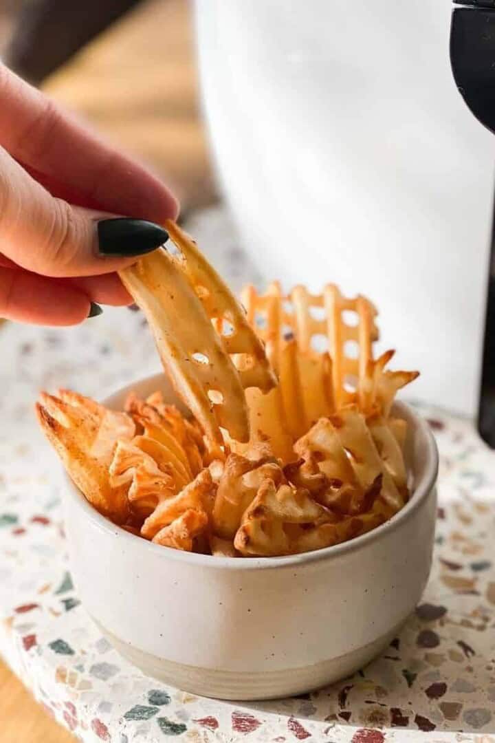 waffle fries in air fryer cooked in a bowl