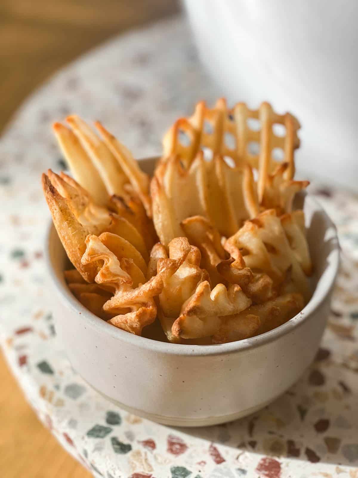 Waffle fries in small bowl