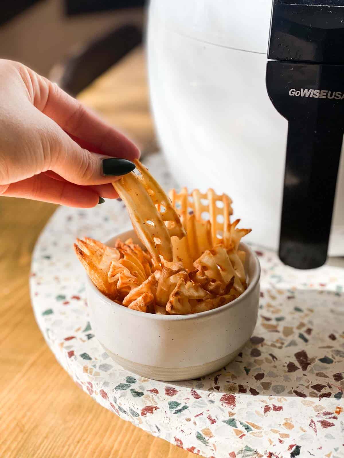 Crispy air fryer waffle fries in small bowl
