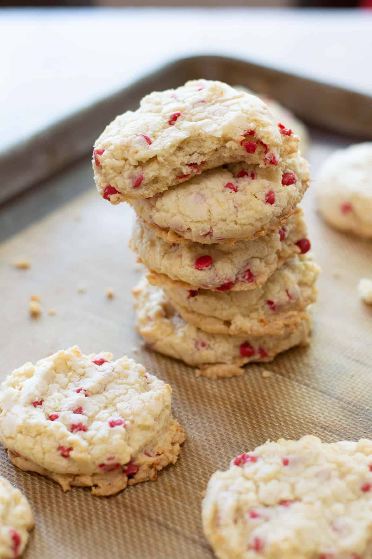 cherry chip cookies stacked on a baking sheet
