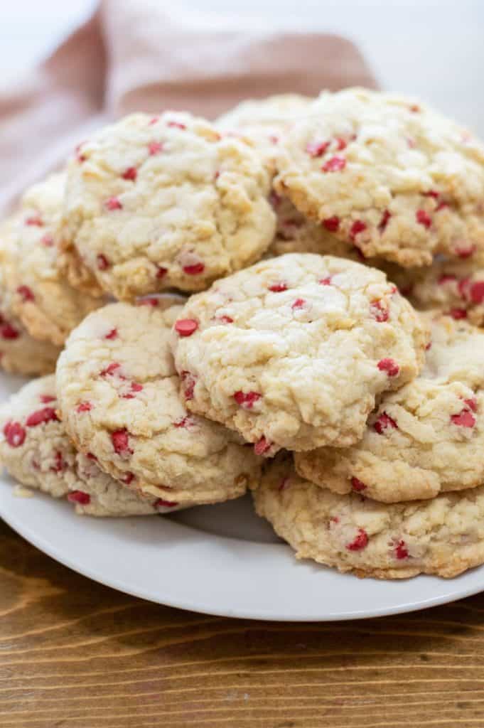 white plate of cherry chip cookies stacked on top of each other