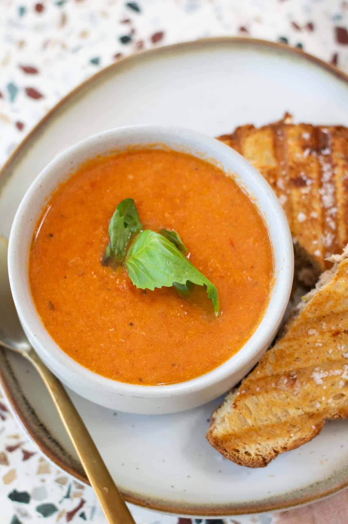 Dairy Free Tomato Soup in a bowl with basil