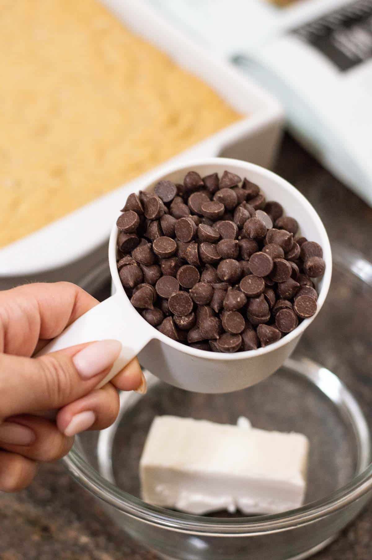 Chocolate chips in a white measuring cup