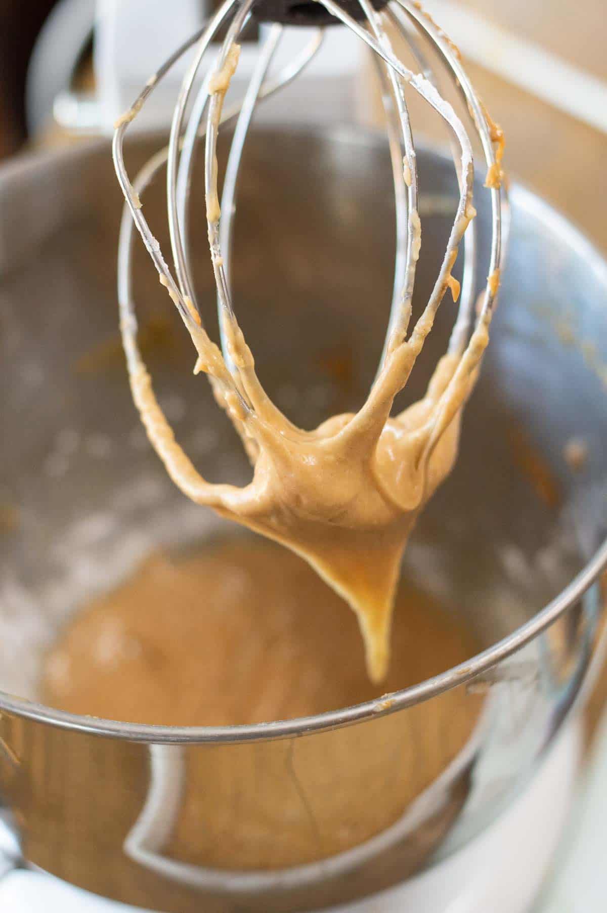 peanut butter frosting on a wire whisk