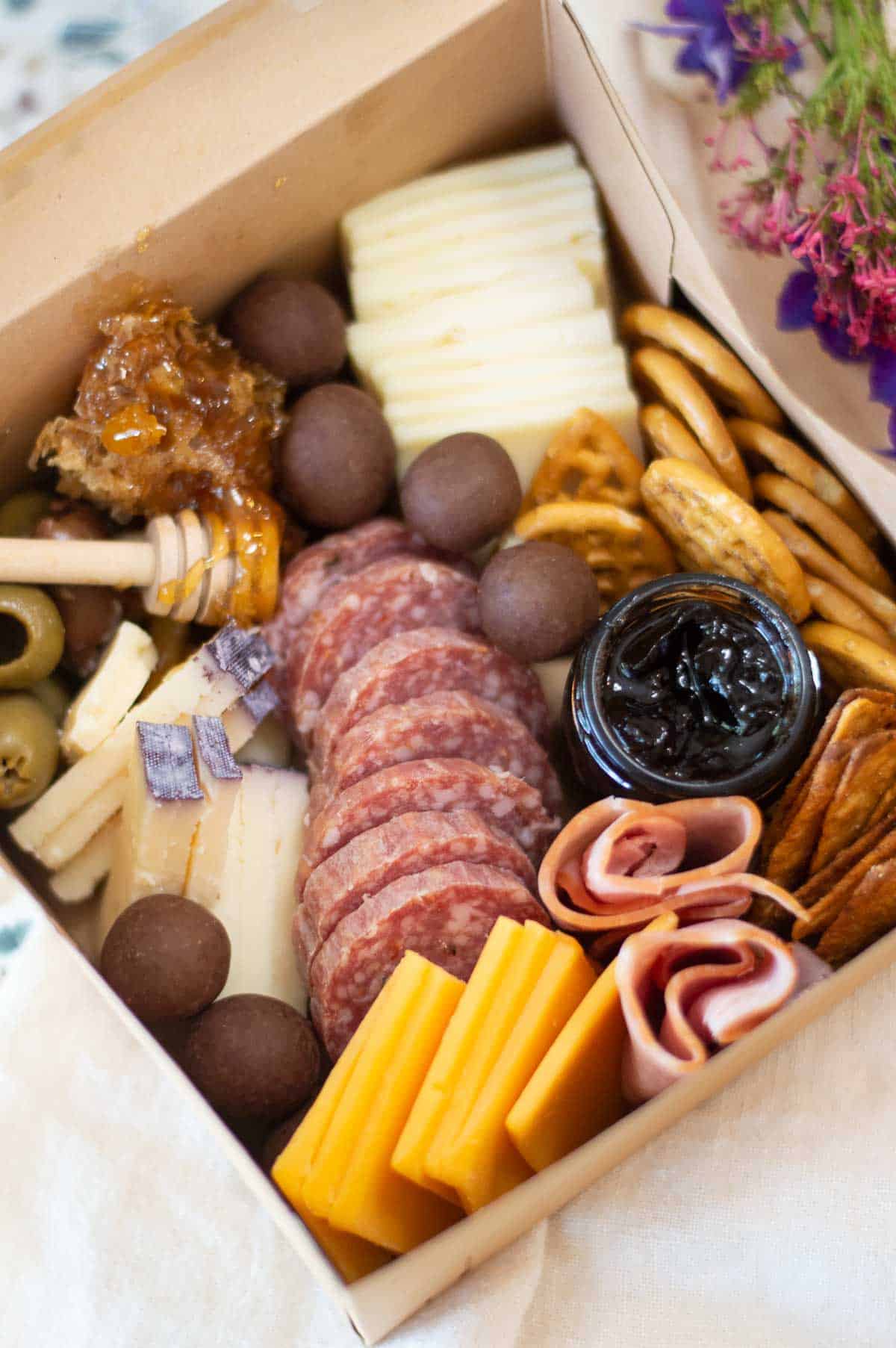 individual charcuterie box with honey