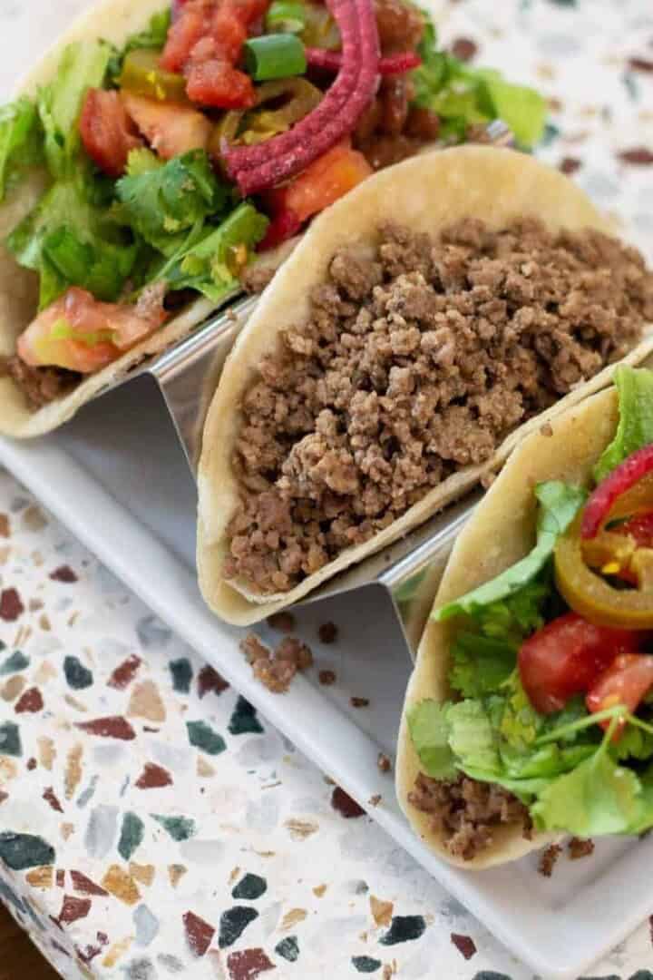Three tacos on a taco holder