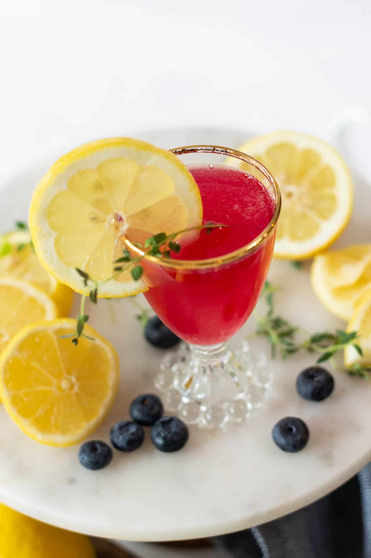 Blueberry Mocktail in a gold rimmed glass