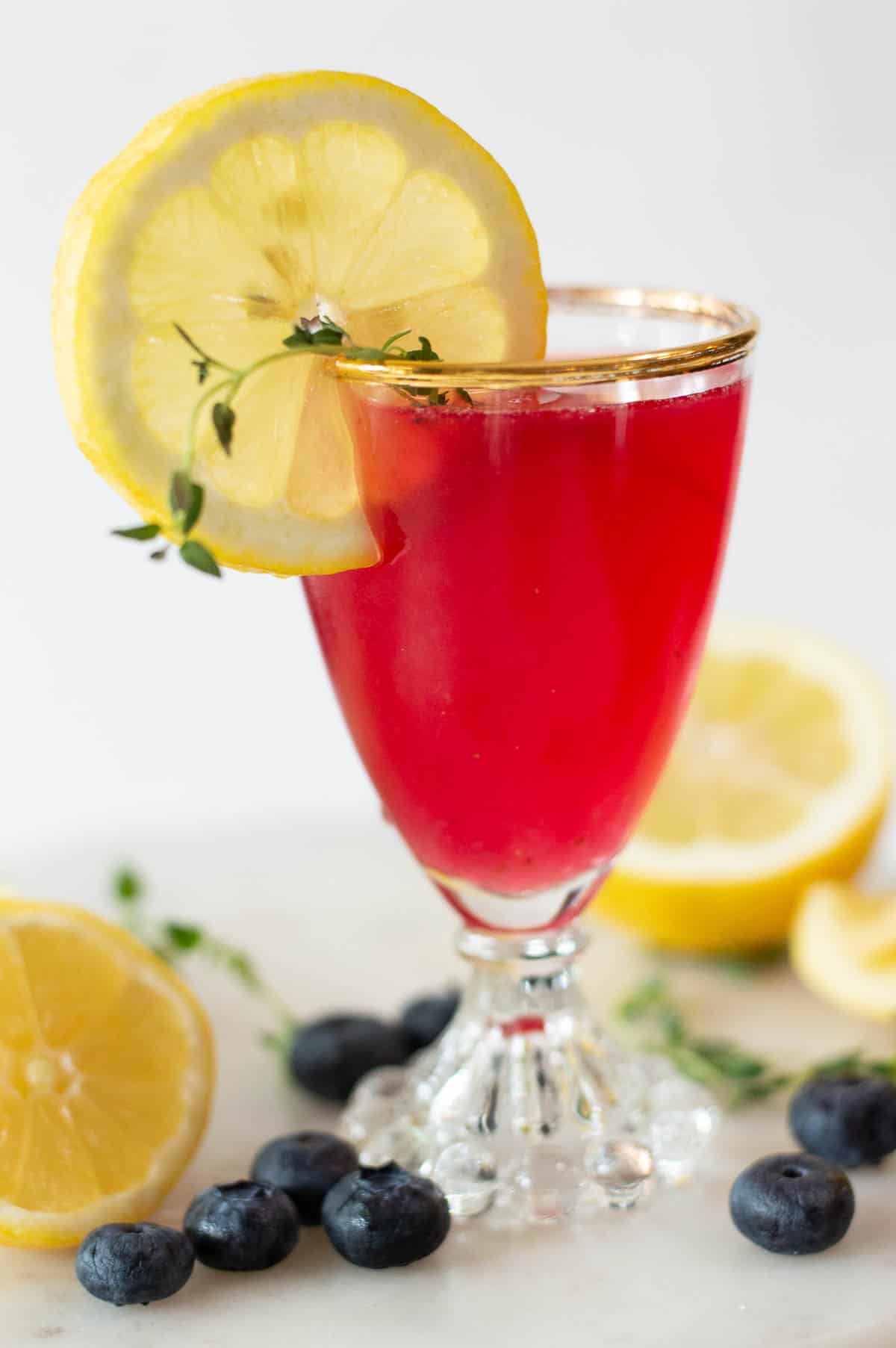 Blueberry mocktail with lemon and thyme in a glass cup