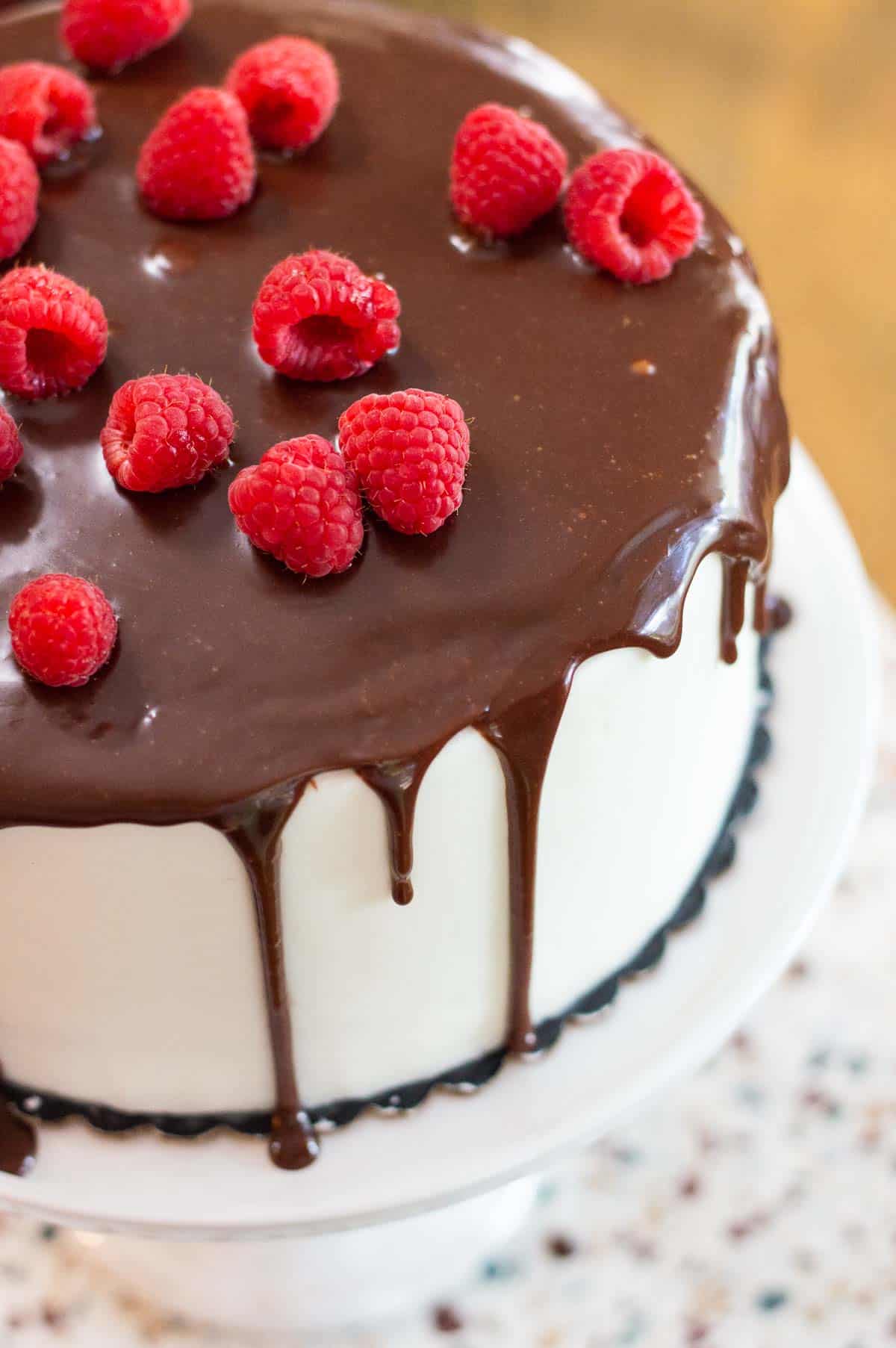 chocolate drip cake topped with raspberries