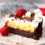 Slice of Gluten Free Banana Black Bottom Pie with a cookie crumb layer, banana pudding layer, and whipped cream layer sitting on a plate