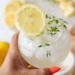 lemon mocktail with thyme and sliced lemon