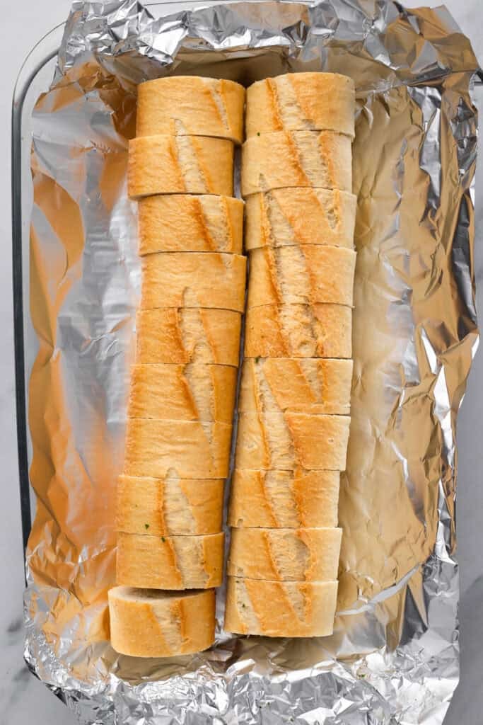 gluten free garlic bread sliced on tinfoil