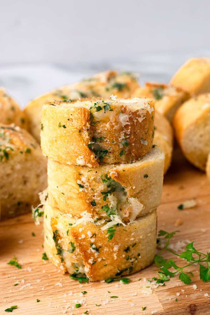 gluten free garlic bread sliced on a wood cutting board stacked