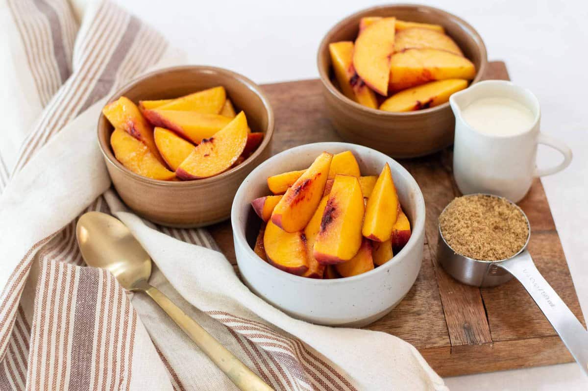 Fresh peaches in bowls