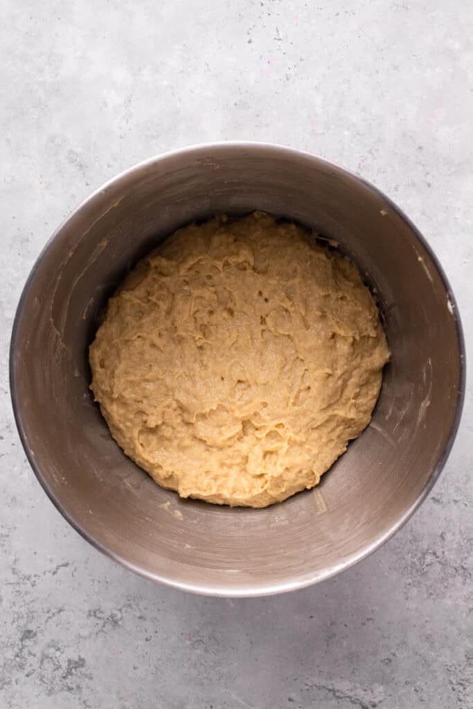 Gluten free apple fritter ingredients in a bowl with dough mixed together.