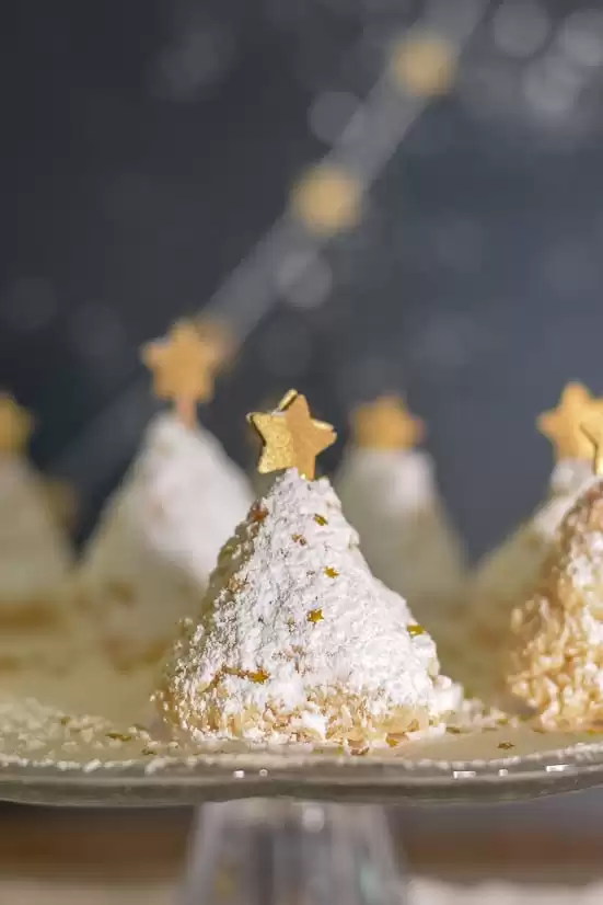 Coconut Christmas tree cookies with gold stars on top