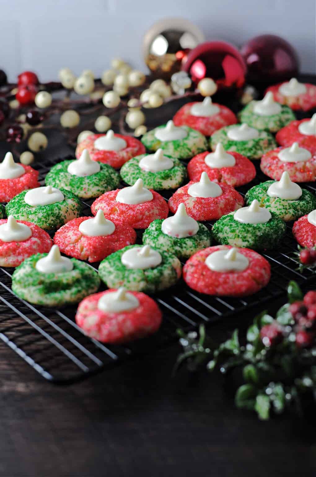 Red and green sugar cookie blossoms with white chocolate kisses melted on top