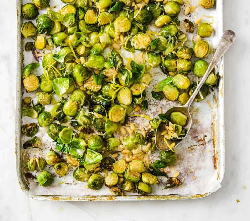 Roasted brussels sprouts with parmesan on a baking sheet