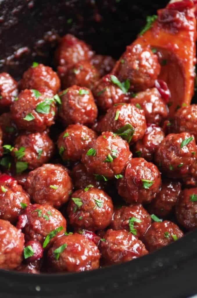 Cranberry meatballs covered in sauce and garnish