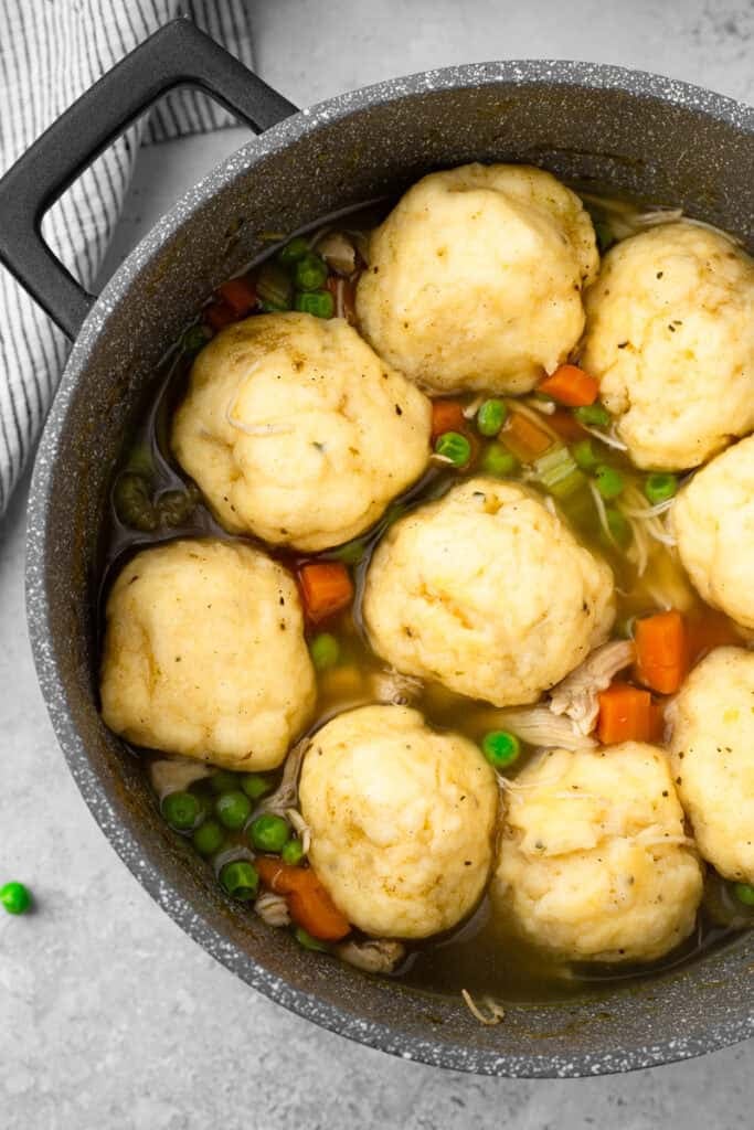 top down image of chicken and dumplings with large fluffy dumplings