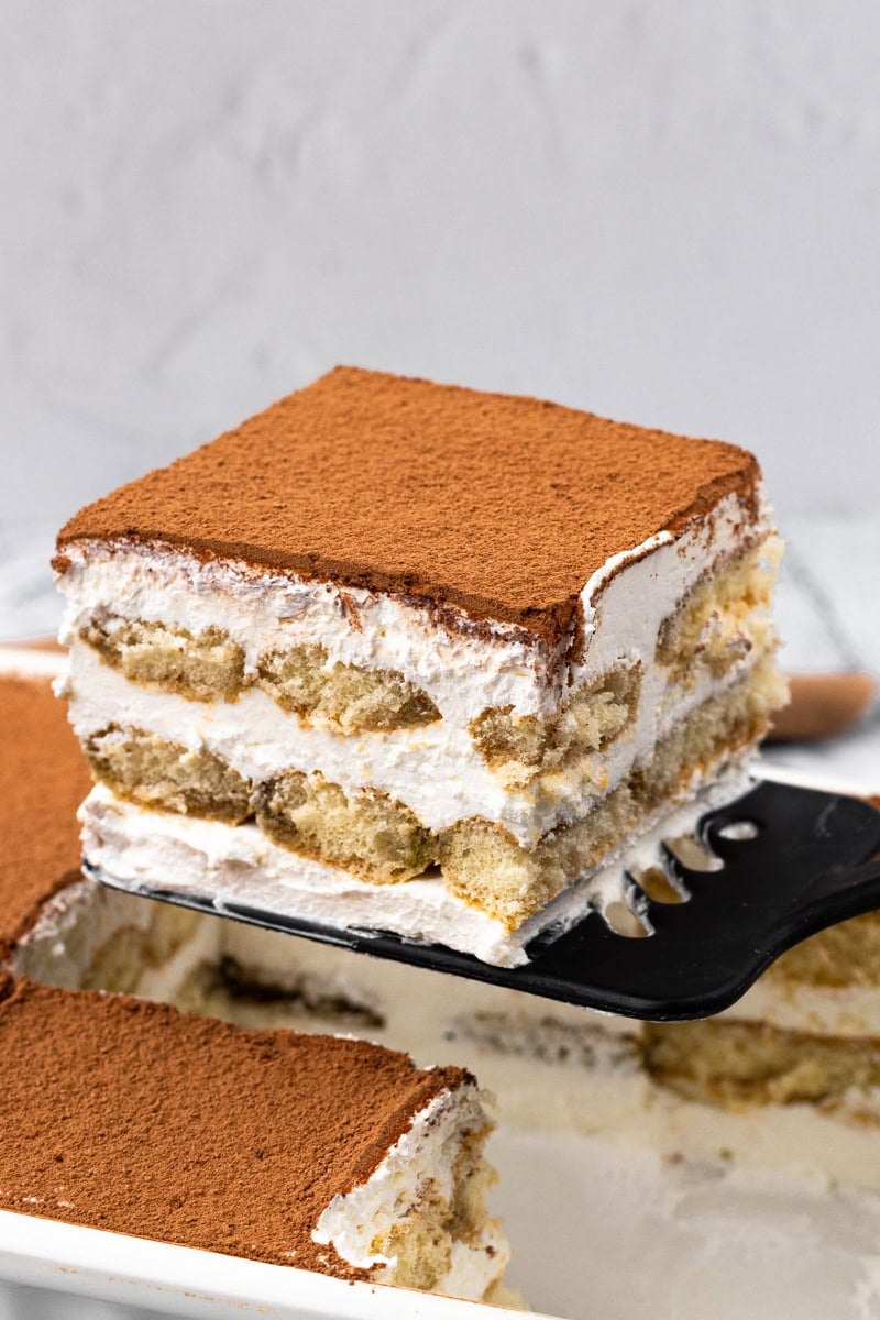 Easy 15-Minute Gluten Free Tiramisu on a spatula ini a square slice