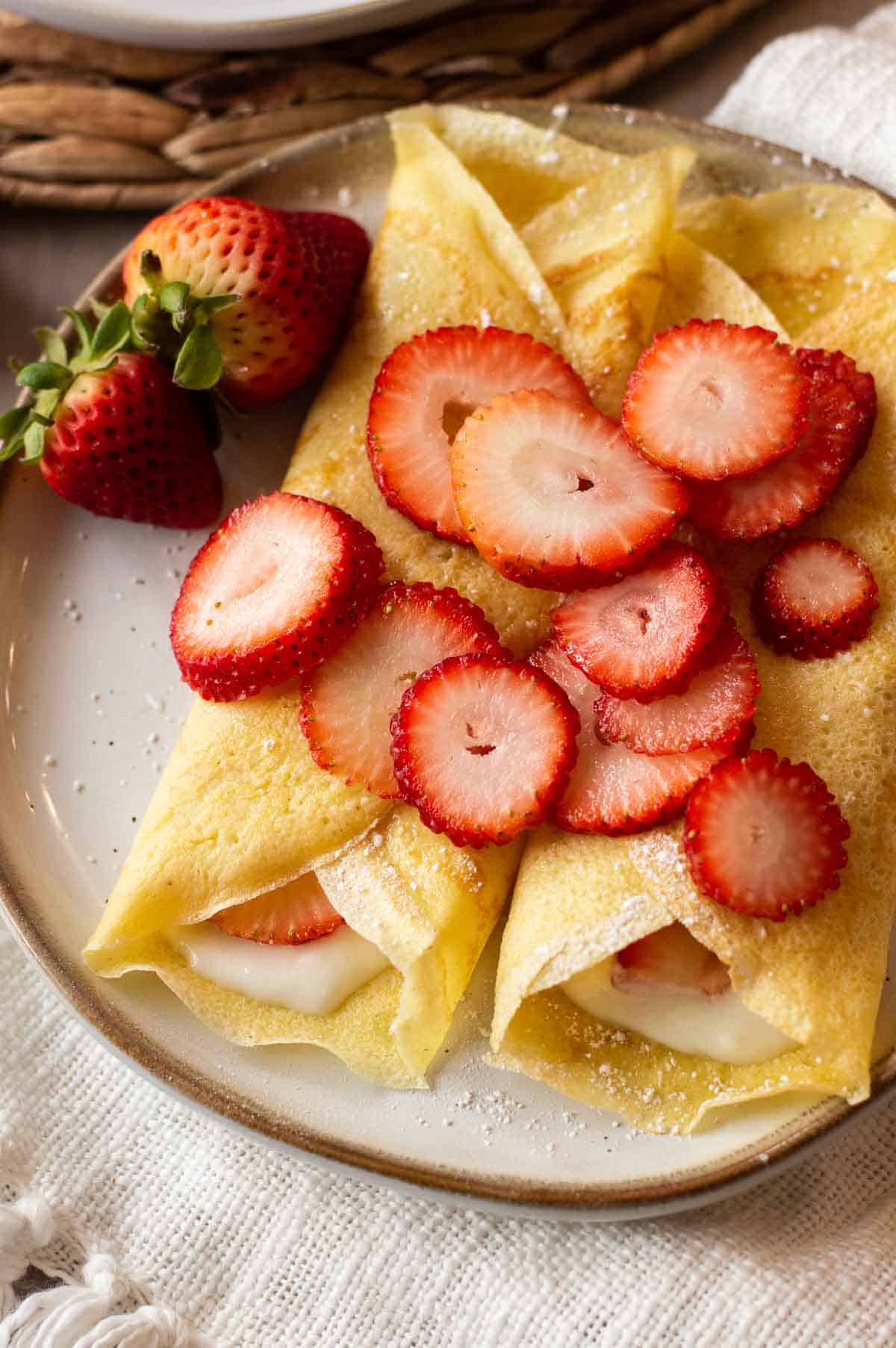 gluten free crepes on a plate with strawberries