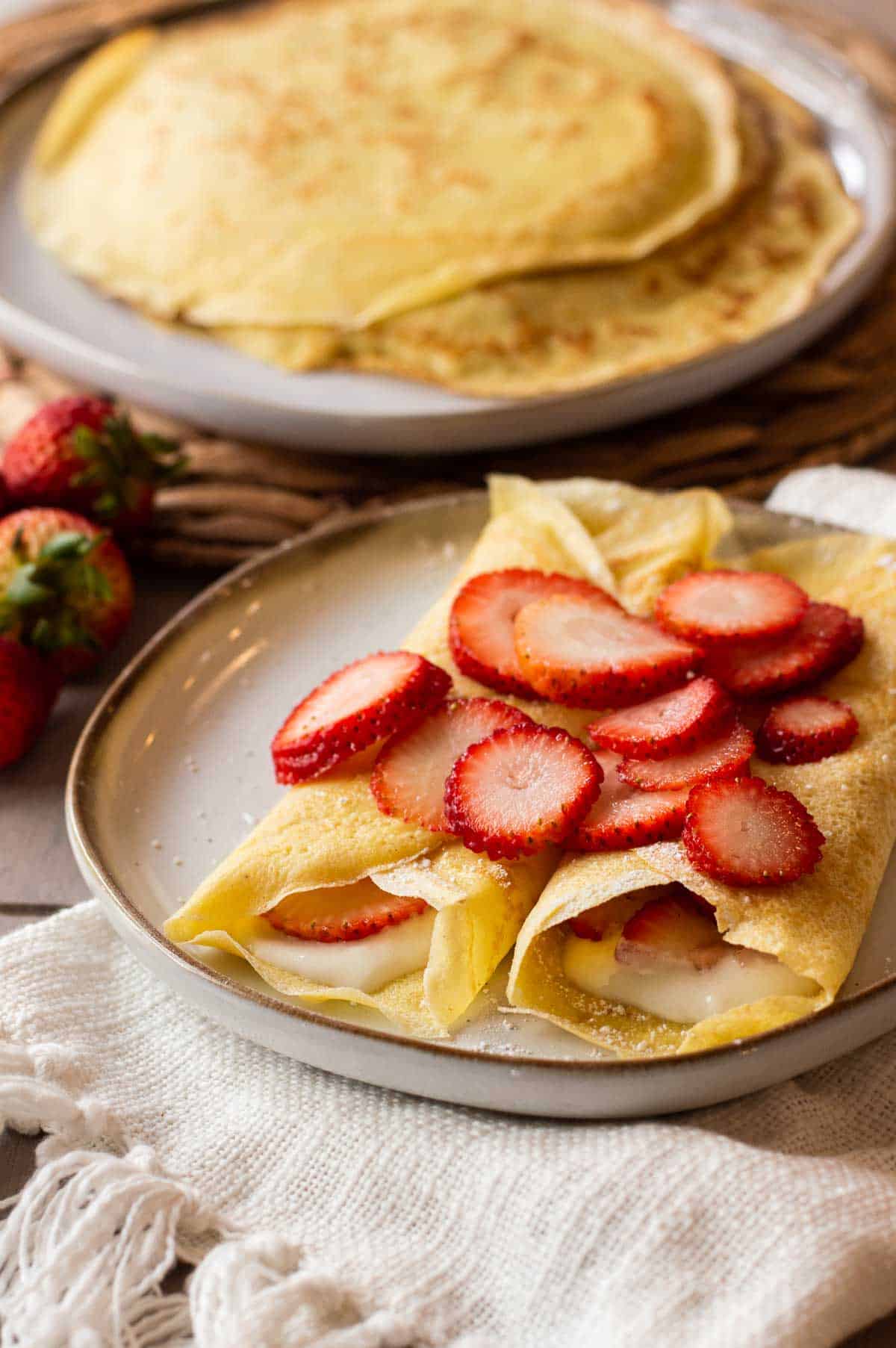 gluten free crepes on a plate with strawberries