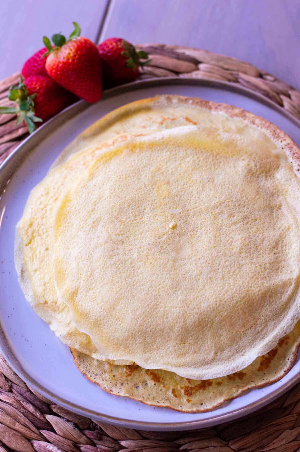 gluten free crepes on a plate with strawberries