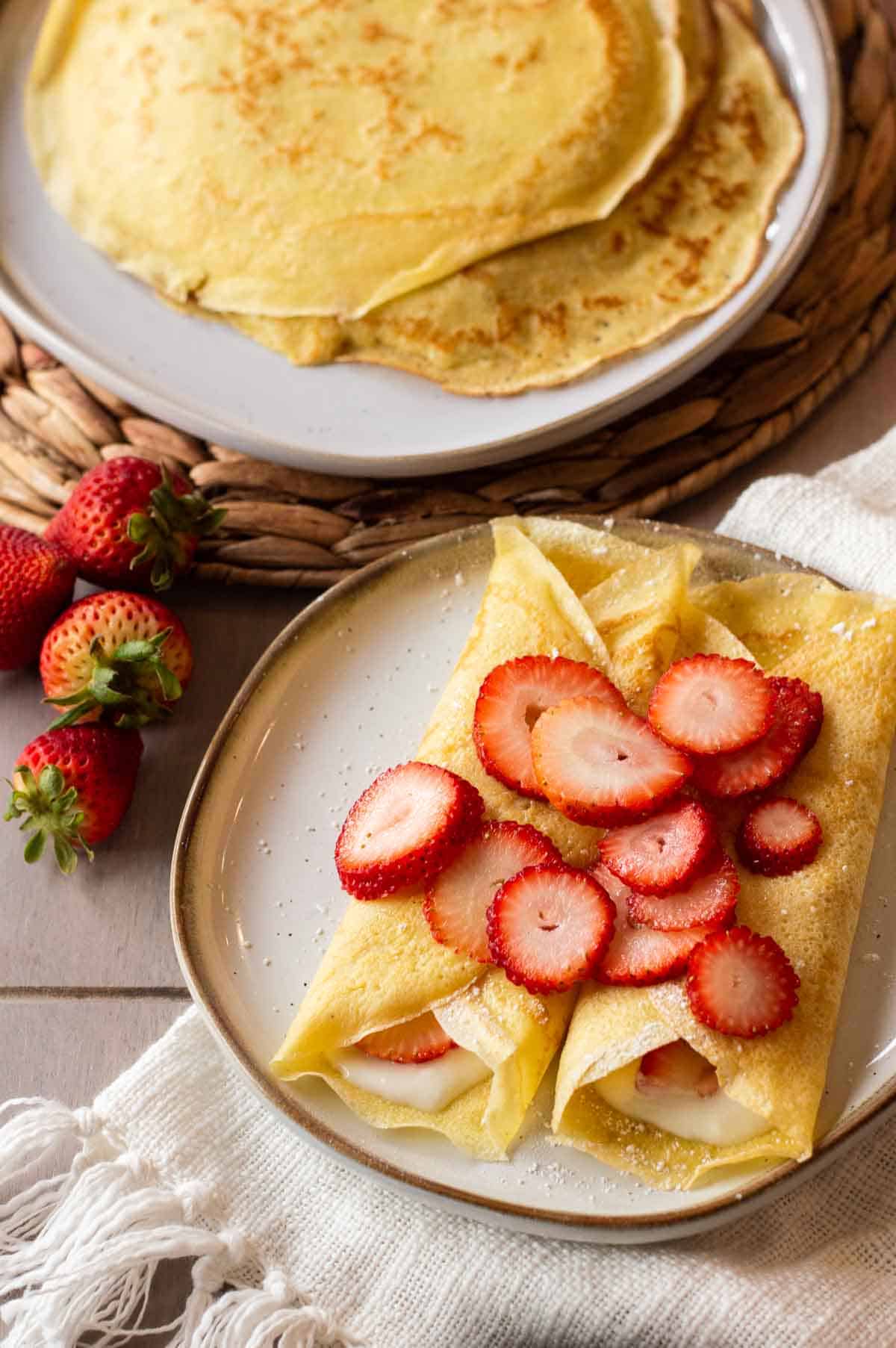 gluten free crepes on a plate with strawberries