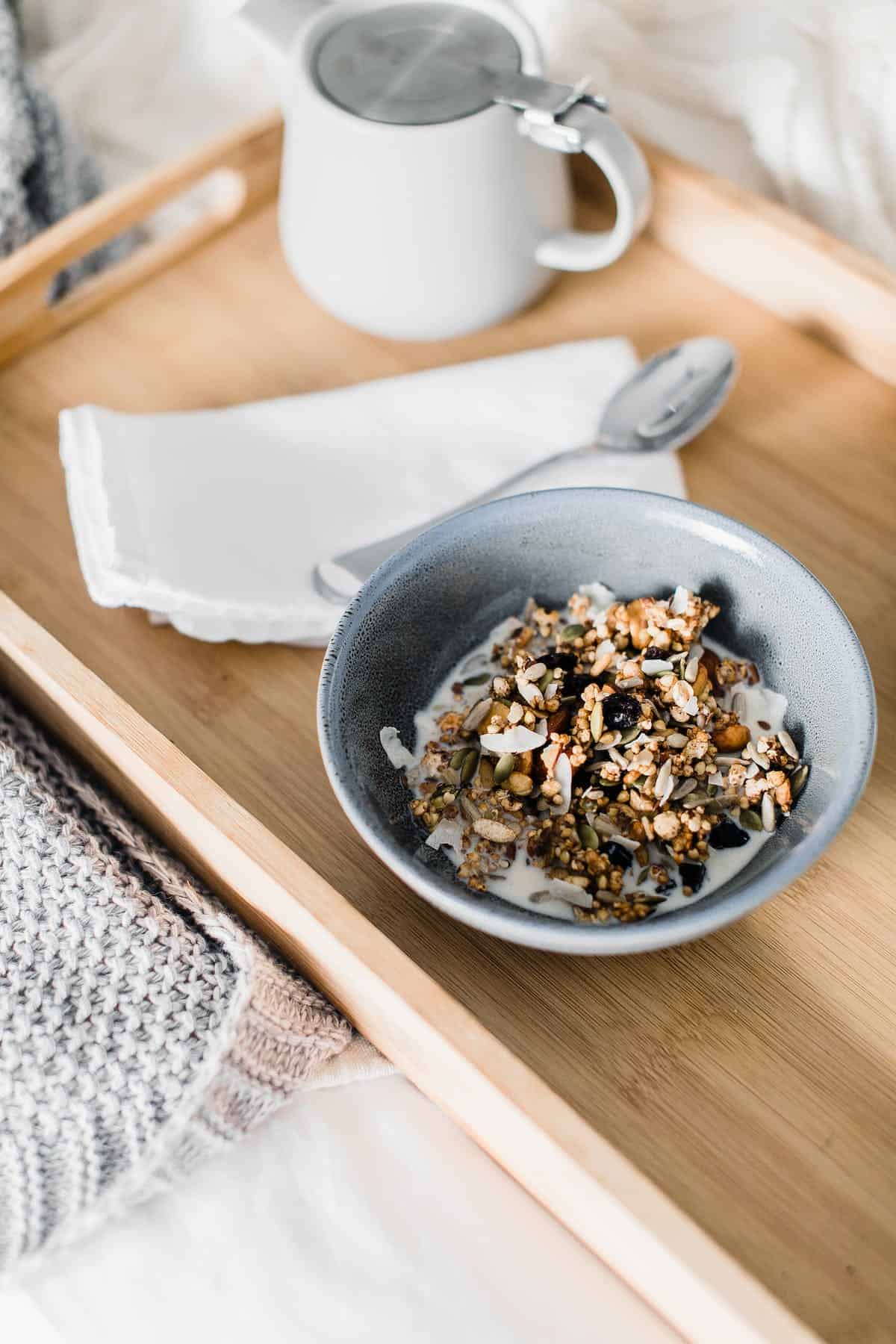 Muesli in a bowl on a wood tray