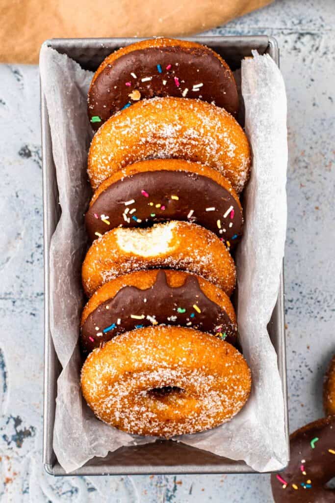Gluten Free Donuts (Fried, Bakery Style) in a tray with chocolate frosting and sugared outsides
