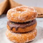 Gluten Free Donuts (Fried, Bakery Style) stacked on top of each other with chocolate frosting and sugared outsides