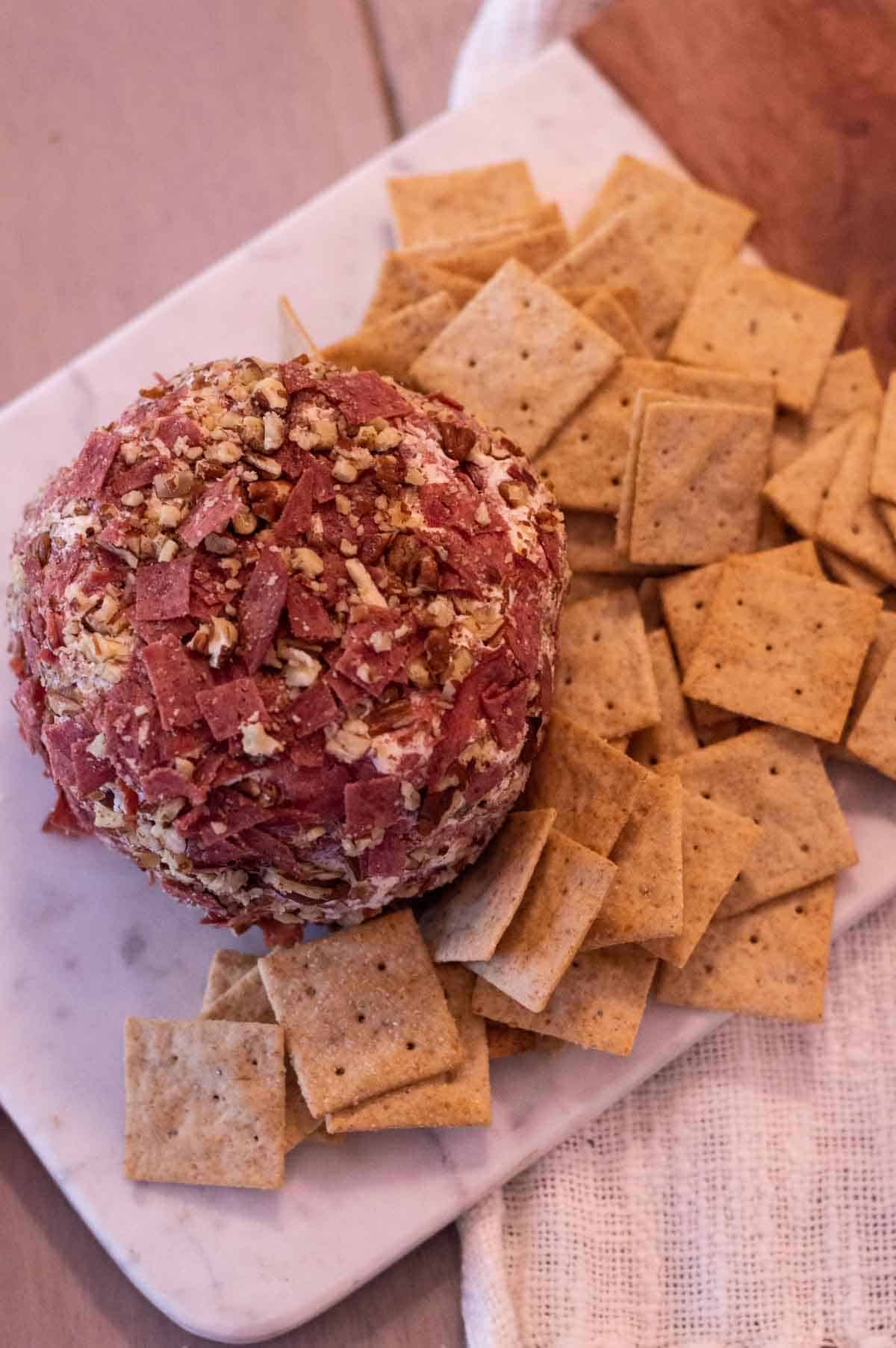 Best Beef Cheeseball on a platter with crackers