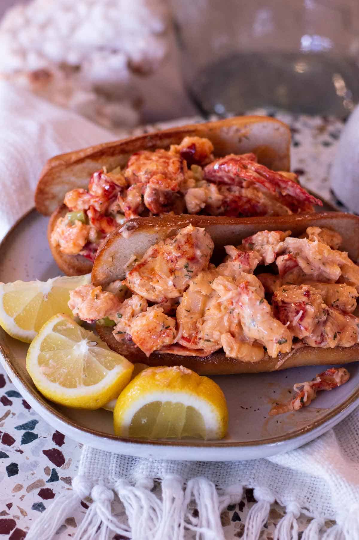 Gluten Free Lobster Rolls on a plate with lemon