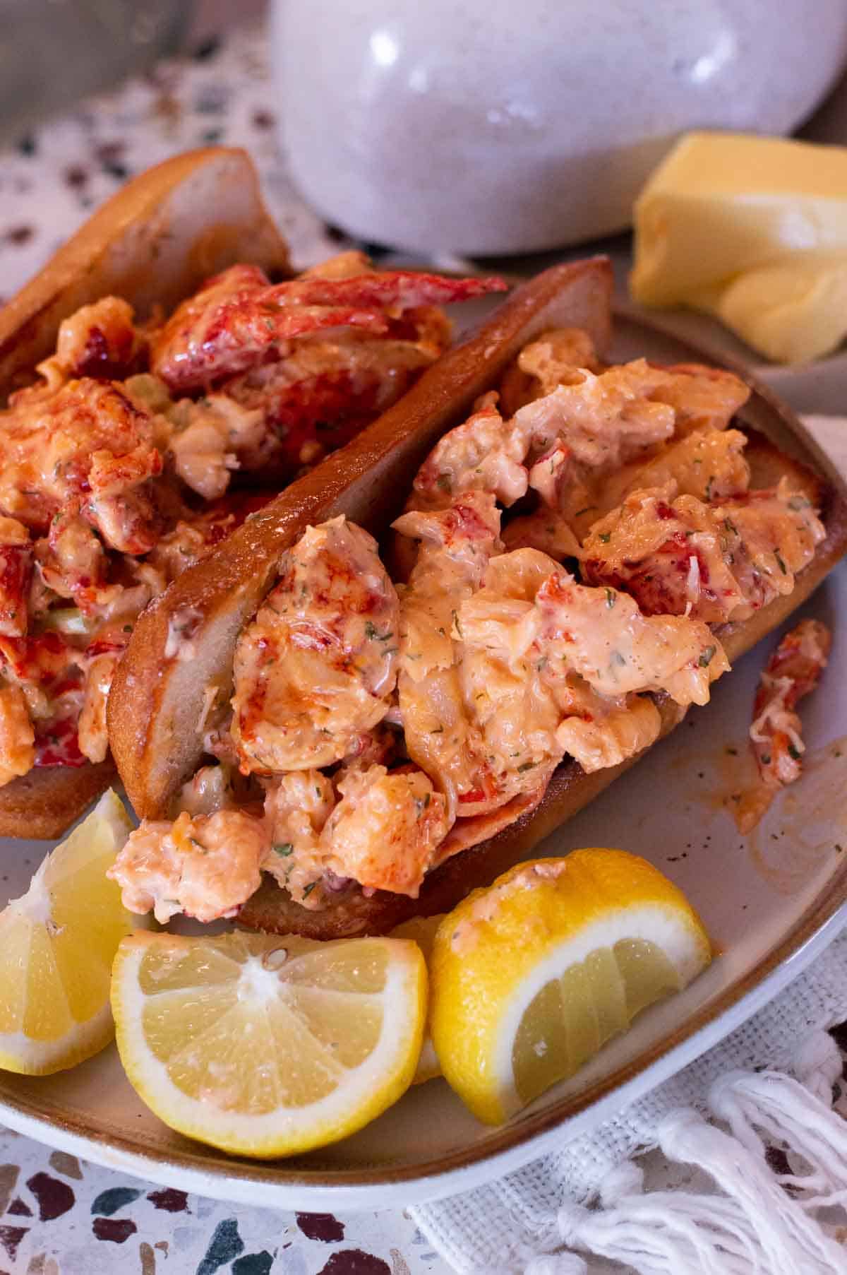 Gluten Free Lobster Rolls on a plate with lemon