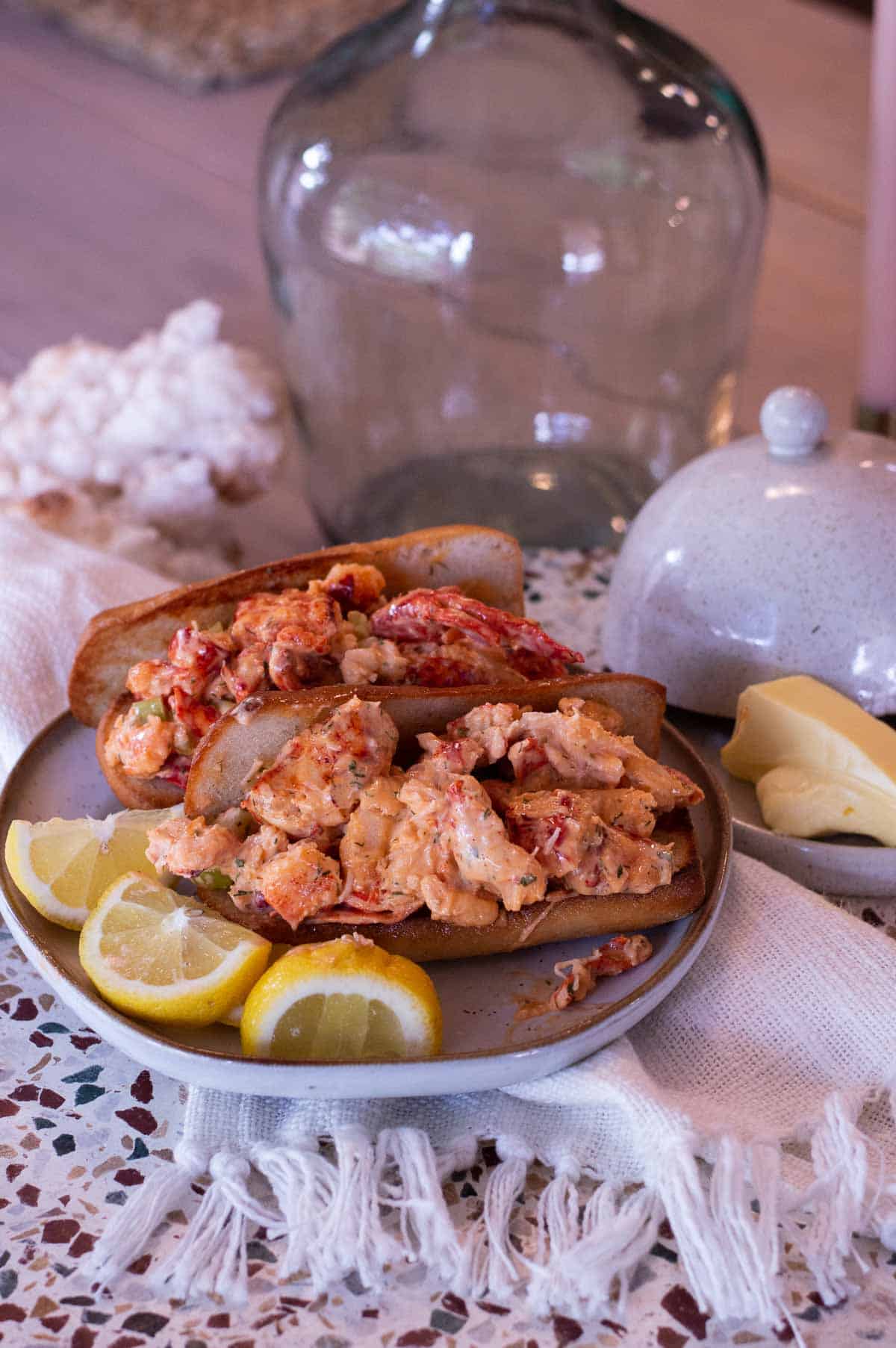 Gluten Free Lobster Rolls on a plate with lemon