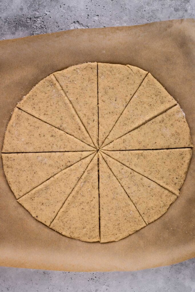 gluten free crescent roll dough rolled out into a circle with triangles cut