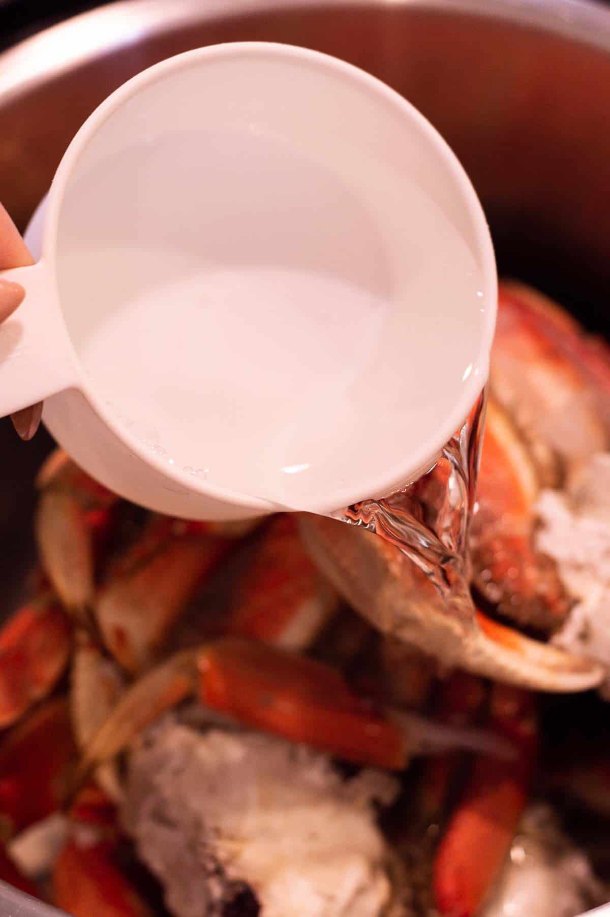 Crab Legs in the Instant Pot with water pouring in
