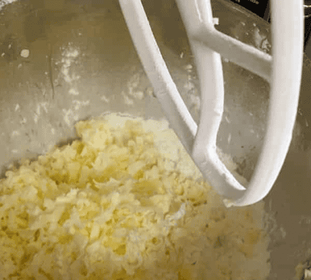 frozen shredded butter in a kitchen aide with a white paddle