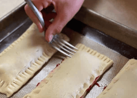 gluten free pop tarts being made and fork crimping sides
