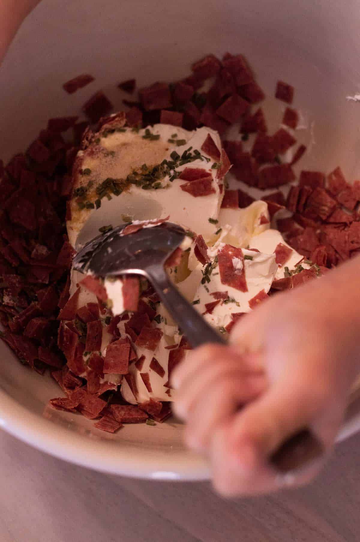 cream cheese and dried beef being mixed