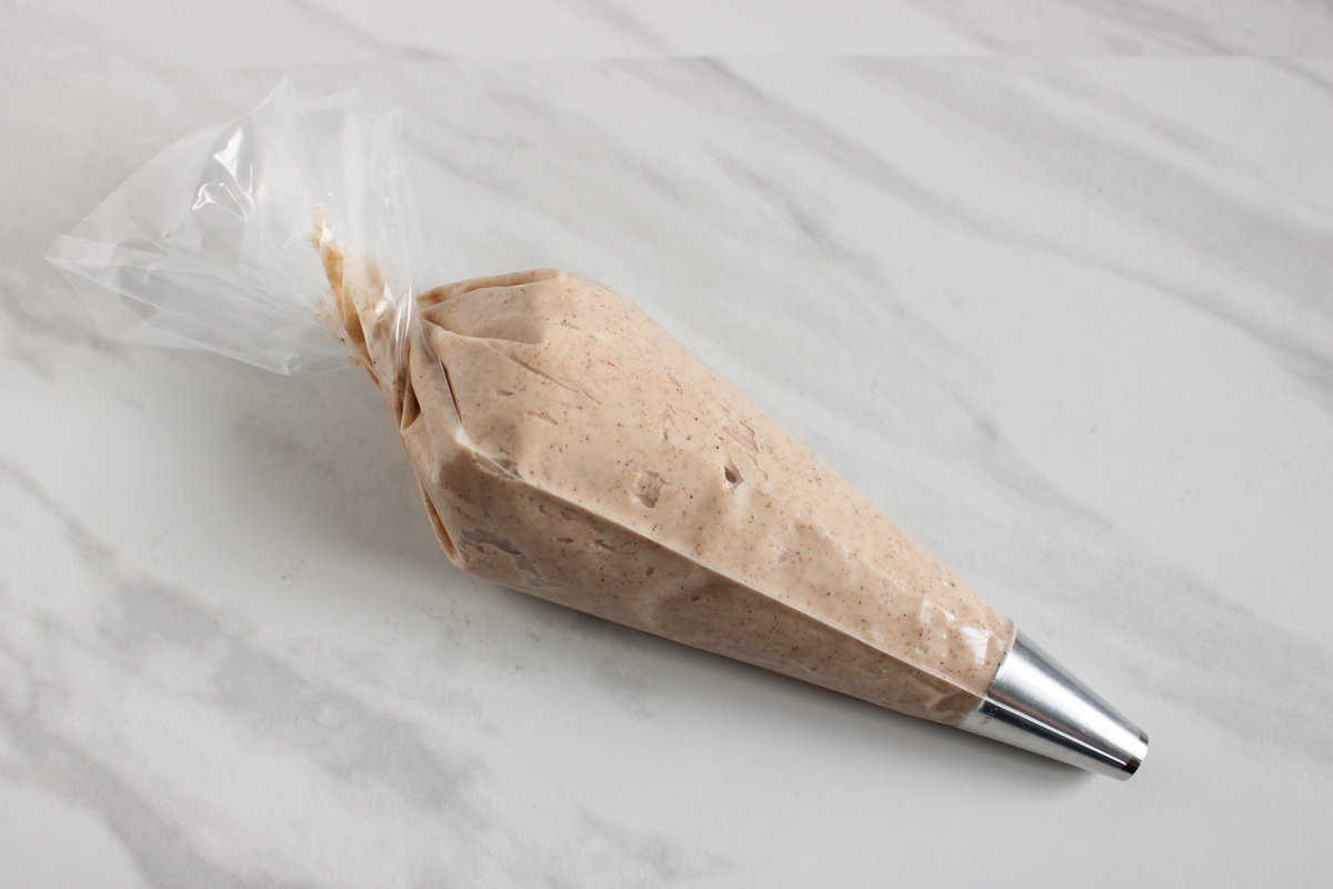 spiced pumpkin cream cheese frosting in a piping bag